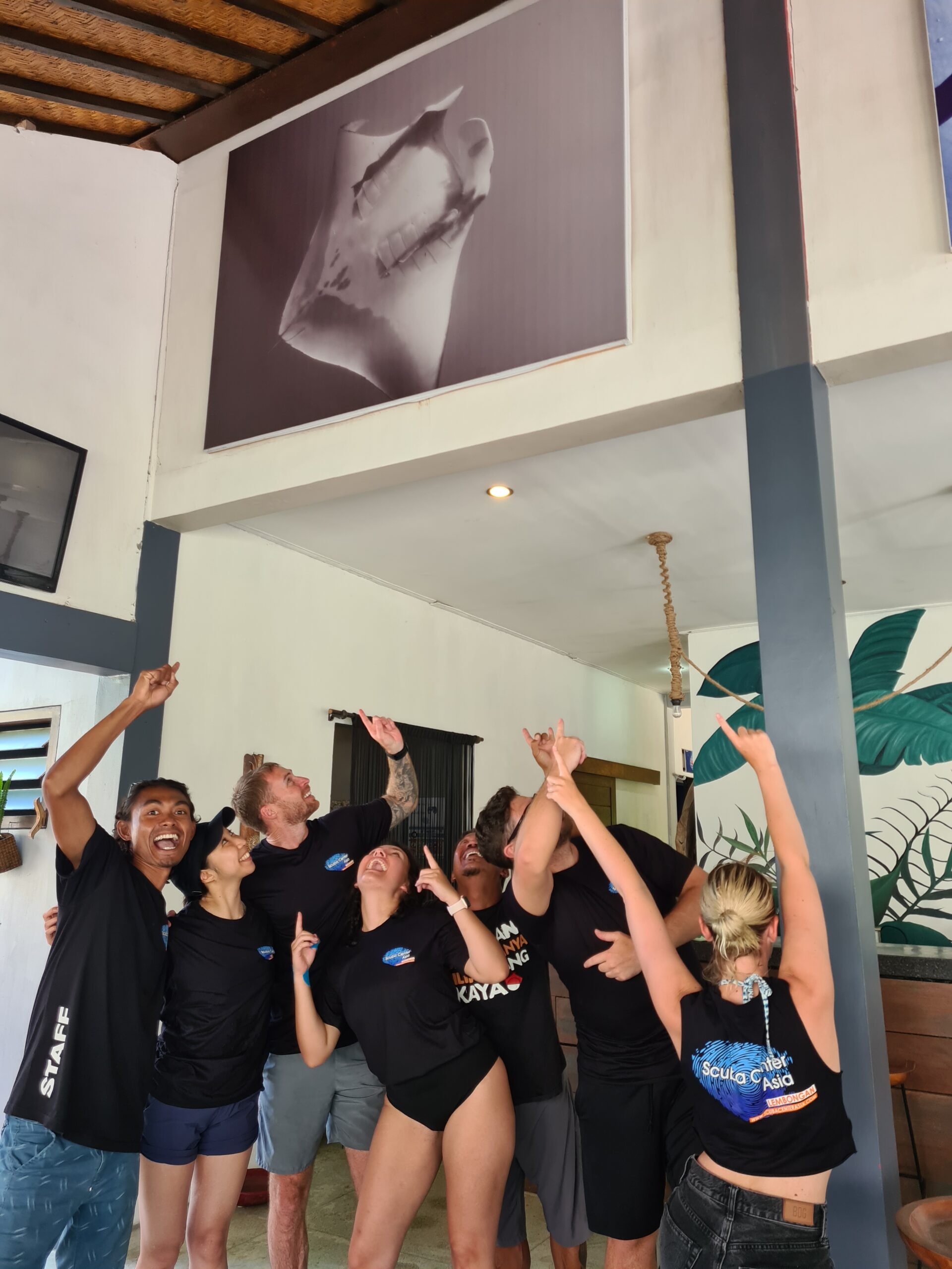 happy divers at dive center with manta
