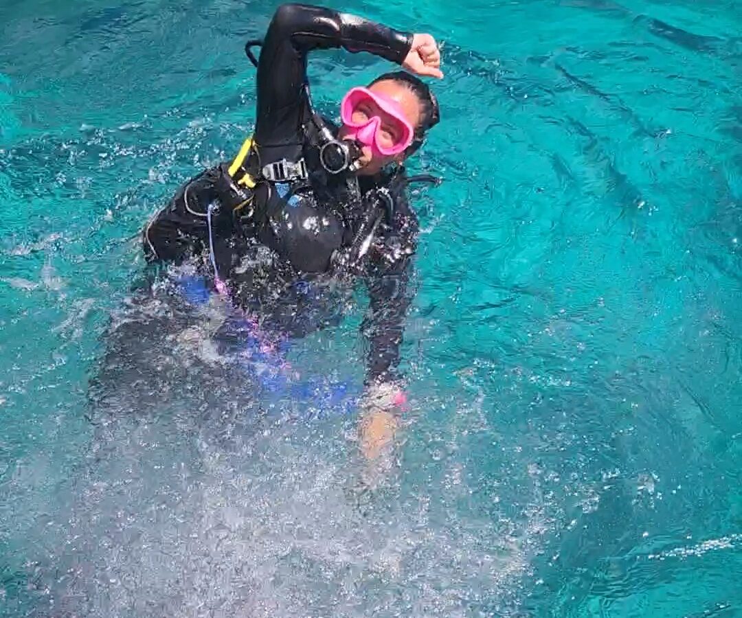 Happy girl diver in the water