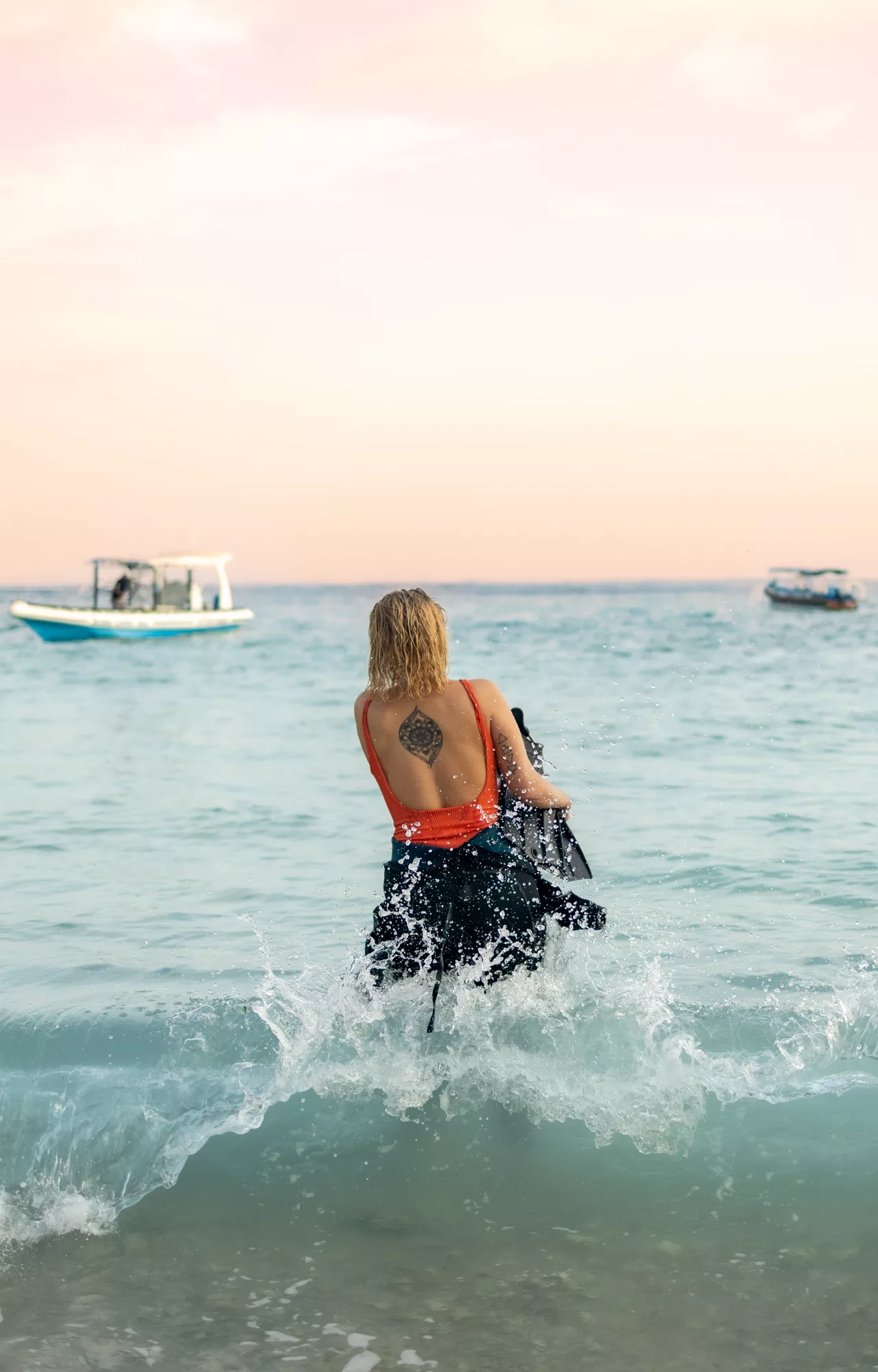 PADI Rescue diver trainee entering the ocean during a dynamic rescue scenario at Scuba Center Asia