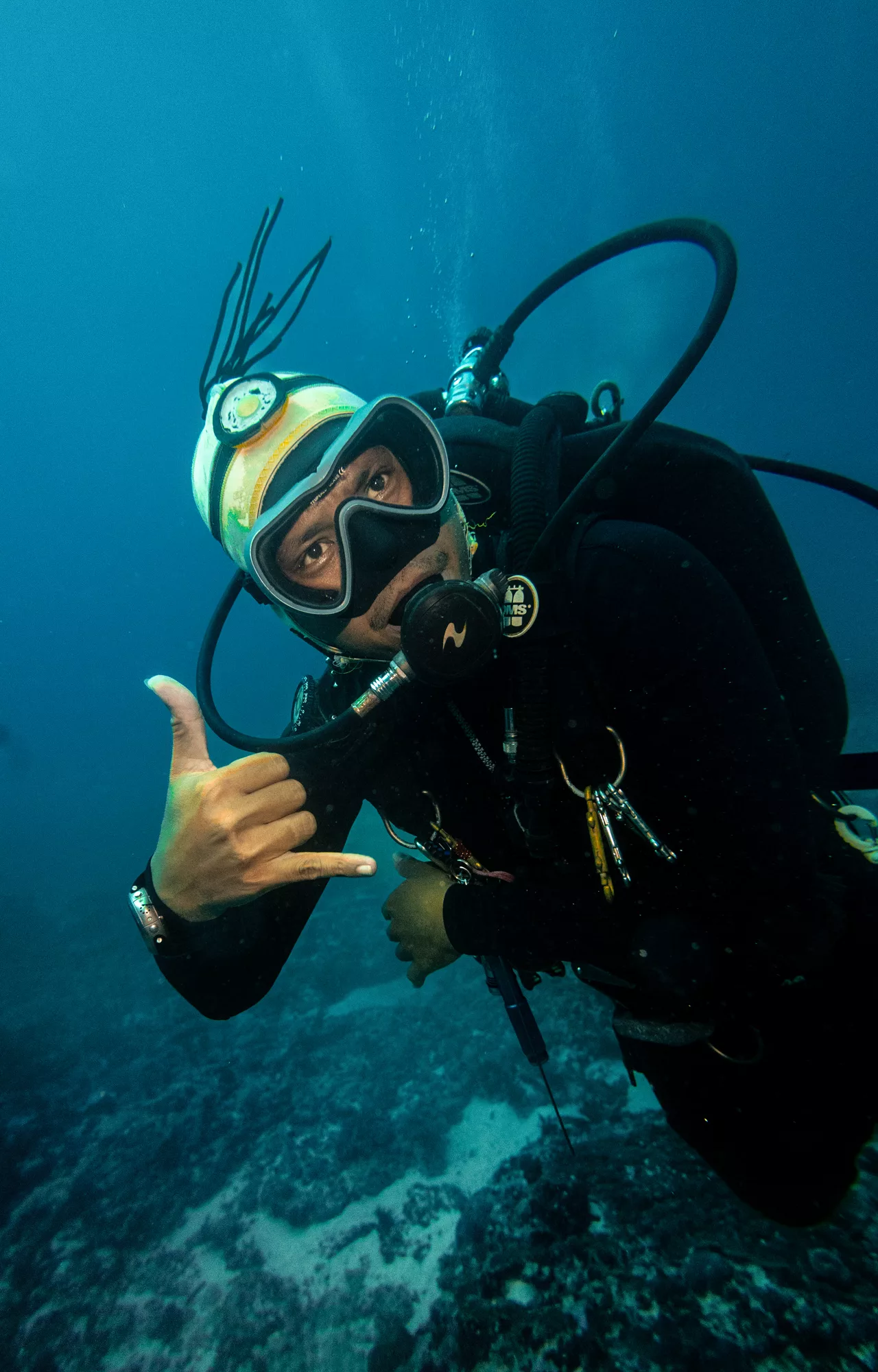 staff instructor underwater signalling he is having the time of his life
