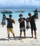 proud dive instructors showing the garbage collected during the monthly beach clean up by scuba center asia